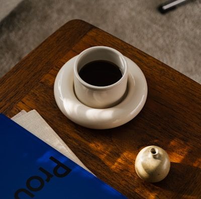 a cup of coffee and a book on a table