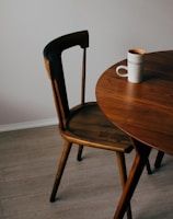 white ceramic mug on brown wooden table