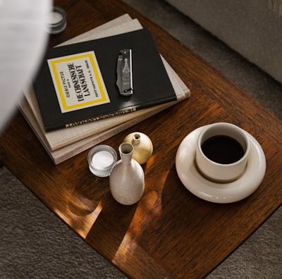 a coffee table with a book and a vase on it