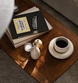 a coffee table with a book and a vase on it